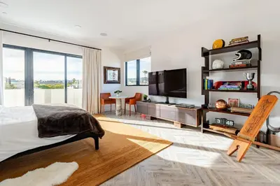 a bedroom with a bed and a flat screen tv at Abracadabra Ultra Luxury Private Residence in Los Angeles