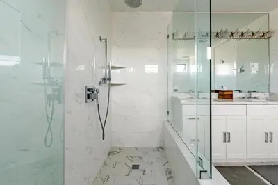 a white bathroom with a shower and a sink at Abracadabra Ultra Luxury Private Residence in Los Angeles