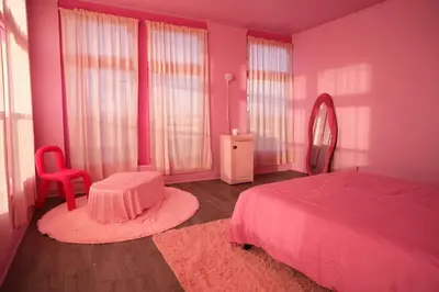a pink bedroom with a bed and a mirror at Paradise Knowhere in Los Angeles