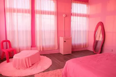 a pink bedroom with a bed and a mirror at Paradise Knowhere in Los Angeles