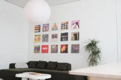 a living room with a couch and pictures on the wall at Paradise Knowhere in Los Angeles