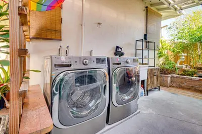 two washing machines sitting next to each other in a garage at Explore Shops, Eats and Entertainment! Pasadena Apt in Pasadena