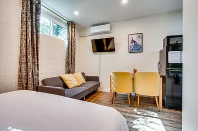 a room with a bed and a couch and a table at 4 Mi to Old Pasadena! Well-Appointed Studio Stay in Pasadena