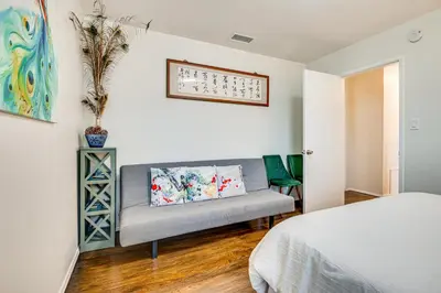 a bedroom with a bed and a couch in a room at Peacock House Sanctuary 4 Mi to Old Pasadena! in Pasadena
