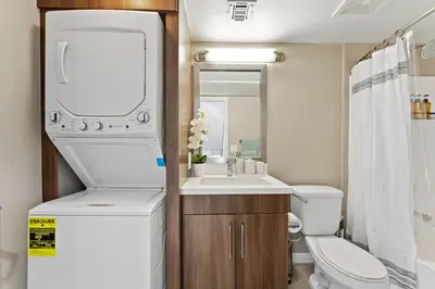 a small bathroom with a toilet and a sink at Vertical Blue Bi-Level Sanctuary with Pacific Vistas in Los Angeles