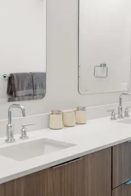 a bathroom with two sinks and a mirror at Urban Tide - A Designer Escape Overlooking the Docks in Los Angeles