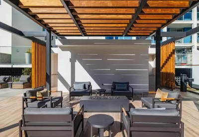 an outdoor patio with couches and chairs and a table at Urban Tide - A Designer Escape Overlooking the Docks in Los Angeles