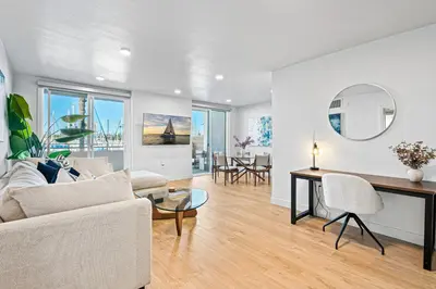 a living room with a couch and a table at Urban Tide - A Designer Escape Overlooking the Docks in Los Angeles