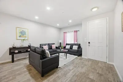 a living room with two couches and a table at Serenity House in Bakersfield