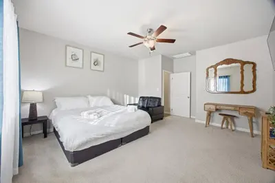a bedroom with a bed and a ceiling fan at Serenity House in Bakersfield