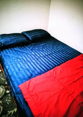 a blue and red bed in a room at The Joshua House in Boron