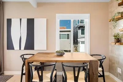 a dining room with a wooden table and chairs at The Drift Manhattan Beach - steps to the ocean in Manhattan Beach
