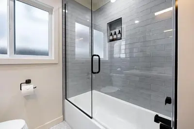 a bathroom with a shower with a glass door at The Drift Manhattan Beach - steps to the ocean in Manhattan Beach