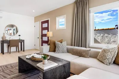 a living room with a couch and a table at The Drift Manhattan Beach - steps to the ocean in Manhattan Beach