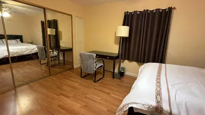a hotel room with two beds and a desk and a mirror at Citrus Loft Room B - Quiet and Convenience Female Only in Covina