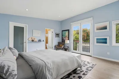 a bedroom with a large bed with blue walls at New Listing West LA Urban Oasis by Colby & Conrad in Los Angeles