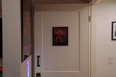 a white door with a picture on the wall at Themed Townhouse Retreat Near LAX and Sofi in Los Angeles