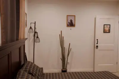 a room with a plant and a white wall at Themed Townhouse Retreat Near LAX and Sofi in Los Angeles