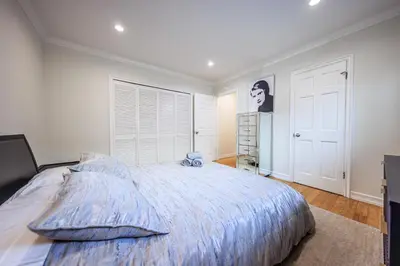 a bedroom with a large bed with a blue comforter at Bright 2 Bedroom Home in the Heart of Santa Monica in Los Angeles