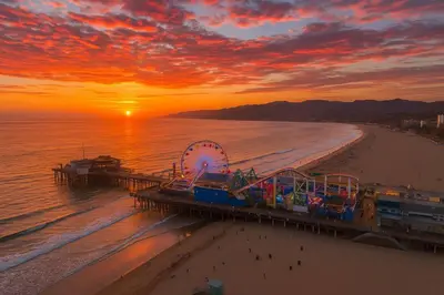a pier on a beach with a roller coaster at Bright 2 Bedroom Home in the Heart of Santa Monica in Los Angeles
