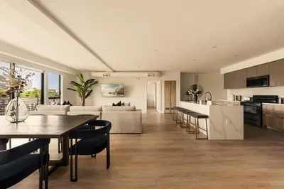 a living room and kitchen with a table and chairs at The Velvet Coast - Grand 3BR Artistic Haven in Los Angeles