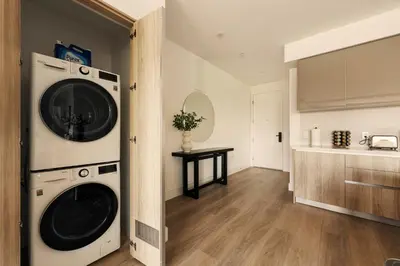 a kitchen with a washer and dryer in a room at The Velvet Coast - Grand 3BR Artistic Haven in Los Angeles