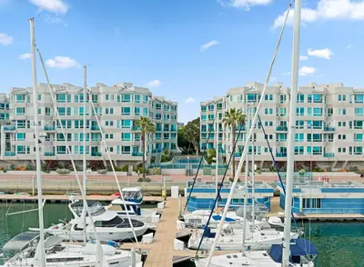 a group of boats docked at a marina with buildings at Ocean's Edge 2BR Penthouse - Infinite Blue Views in Los Angeles