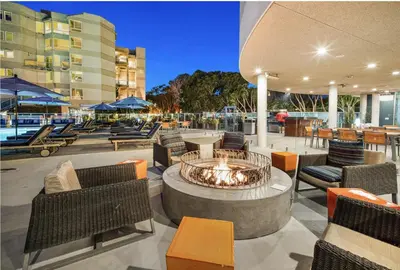 a patio with a fire pit and chairs and tables at Ocean's Edge 2BR Penthouse - Infinite Blue Views in Los Angeles
