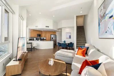 a living room with a couch and a table at Ocean's Edge 2BR Penthouse - Infinite Blue Views in Los Angeles
