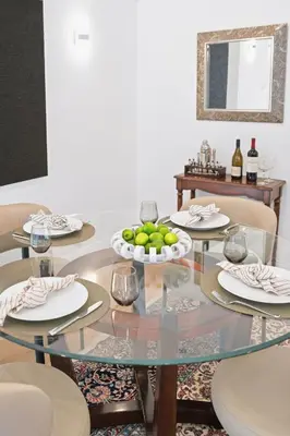 a dining room with a glass table with a bowl of fruit at Beverly Hills Canyon Estate by Colby & Conrad in Los Angeles