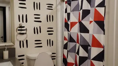 a bathroom with a toilet and a shower at Pop Art Themed Bedroom in House-Shared Bathroom-Shared Living Room & Kitchen in Los Angeles