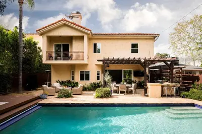 a house with a swimming pool in front of a house at Sherman Oaks Home w Pool, Spa and Outdoor Kitchen in Los Angeles