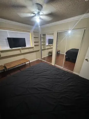 a living room with a ceiling fan and a tv at Oldfield in Lancaster