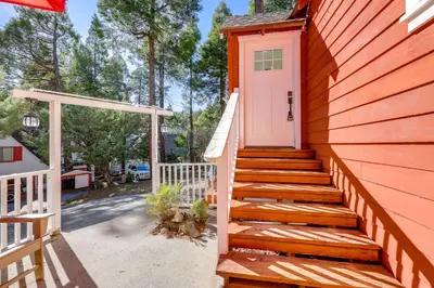 a staircase leading to a house with a pink door at Walk to Lake Arrowhead Village Bright Gem with Deck in Lake Arrowhead
