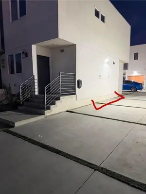 a building with a red hose in a parking lot at The Sunset Gathering in Los Angeles