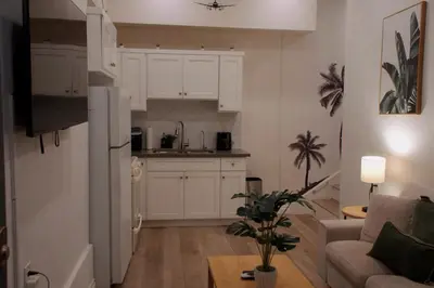 a living room with a refrigerator and a kitchen at The Sunset Gathering in Los Angeles