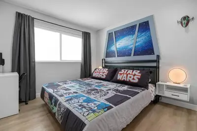 a bedroom with a star wars bed with a large window at Star Wars Retreat by OC Adventure Homes in Garden Grove