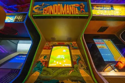a pinball game in a game room with a game console at Star Wars Retreat by OC Adventure Homes in Garden Grove