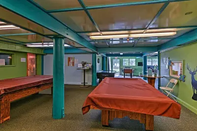 a room with two beds and a table in it at Mtn Views Near Hiking Pine Mountain Club Getaway! in Pine Mountain Club