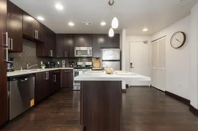 a large kitchen with a large white counter top at West Hollywood Chic Apartment in Los Angeles