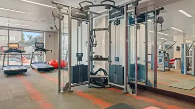a gym with a bunch of treadmills and machines at West Hollywood Chic Apartment in Los Angeles
