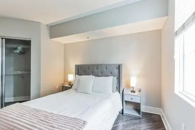 a bedroom with a large bed and two lamps at 3BR 2BTH Santa Monica Apartment - Pool, Balcony, Near LAX in Los Angeles