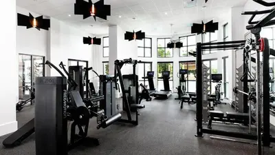 a gym with rows of tread machines in a room at 3BR 2BTH Santa Monica Apartment - Pool, Balcony, Near LAX in Los Angeles