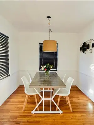 a dining room with a table and white chairs at Spacious 3BR House Culver City Santa Monica & West LA in Los Angeles