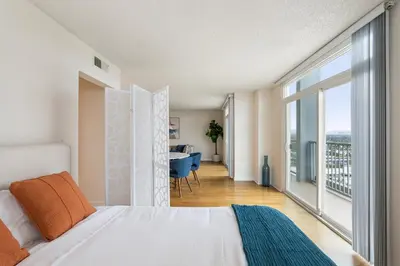 a bedroom with a bed and a large window at Golden Hour Glow - Stunning 3BR Overlooking the Marina in Los Angeles