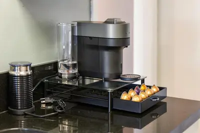 a coffee maker on a counter with a box of donuts at Golden Hour Glow - Stunning 3BR Overlooking the Marina in Los Angeles