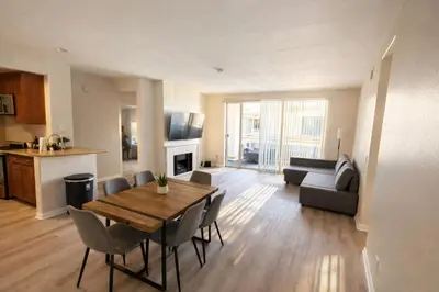 a living room with a table and chairs and a kitchen at Serenity Close To Marina Docks - Short Trip To Venice Beach in Los Angeles