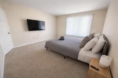a bedroom with a bed and a flat screen tv at Marina Del Rey 2BR-2BA & 1 BR-1BA - Easy Trip To Venice Boardwalk in Los Angeles