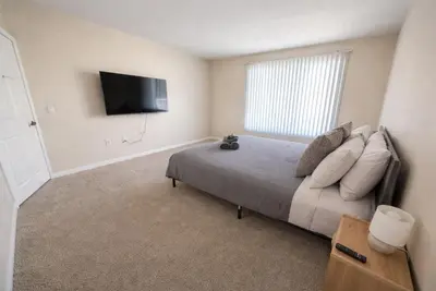 a bedroom with a bed and a flat screen tv at Marina Modern 2BR 2BA in Los Angeles