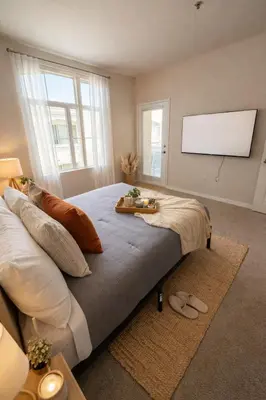 a bedroom with a large bed with a flat screen tv at Marina Modern 2BR 2BA in Los Angeles